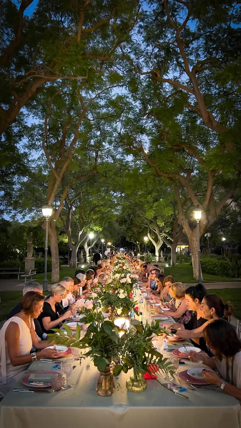Outdoor dining at Josto restaurant in Sardinia, guests enjoying a long table dinner
